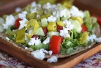 Hummus Pita Pizza Topped with Fresh Greek Salad