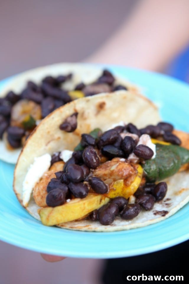 Chicken and Summer Squash Fajitas with Black Beans plate of two tortillas with chicken, squash, and topped with black beans