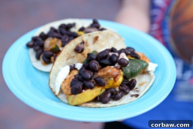Chicken and Summer Squash Fajitas with Black Beans plate of two tortillas with chicken, squash, and topped with black beans