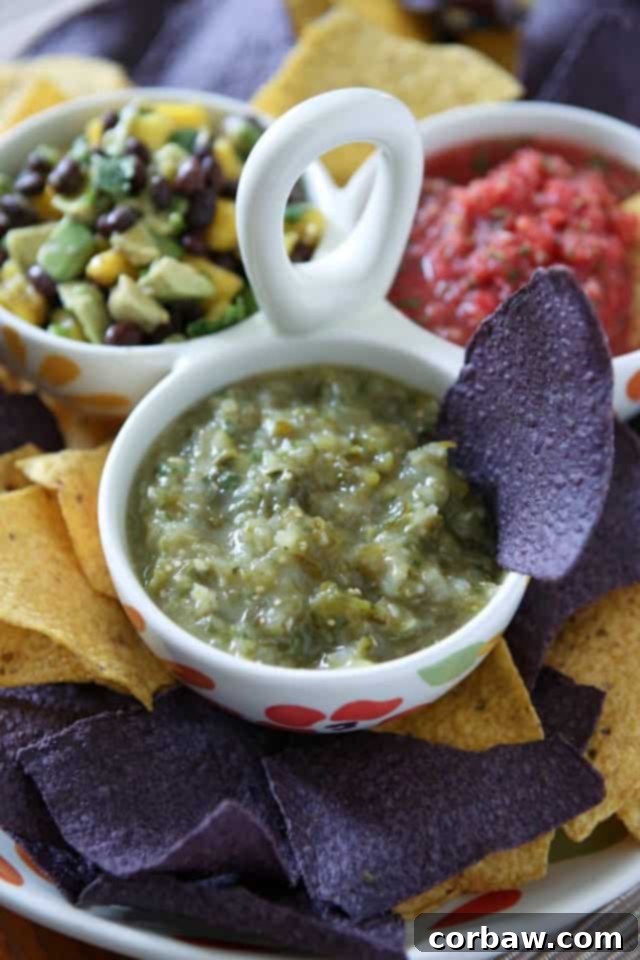 Zesty Roasted Tomatillo Salsa 2 3 bowl caddy filled with different salsas - fresh tomato salsa, tomatillo salsa and avocado mango salsa