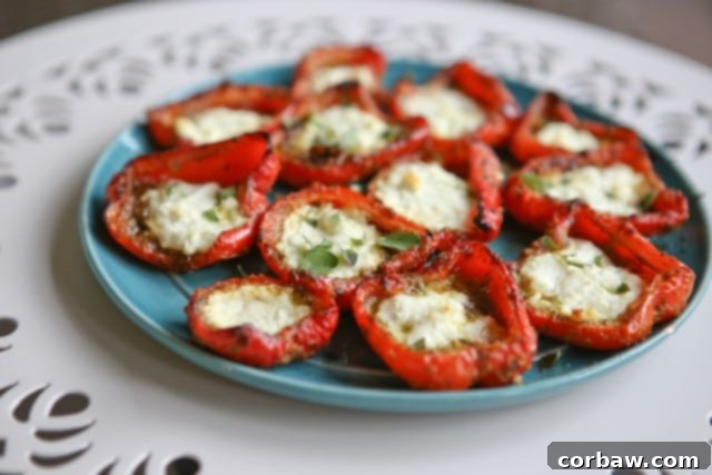 Roasted Red Peppers with Pesto and Goat Cheese Close-up of roasted red peppers with pesto and goat cheese, garnished with fresh herbs