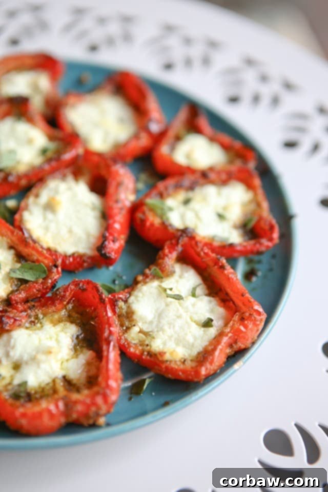 Roasted Red Peppers with Pesto and Goat Cheese A simple, yet impressive, side dish or appetizer - roasted red peppers with pesto and goat cheese are full of flavor and a delicious addition to any meal, served on a rustic board.