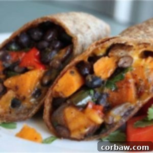 Two halves of a delicious Roasted Veggie and Black Bean Burrito on a plate