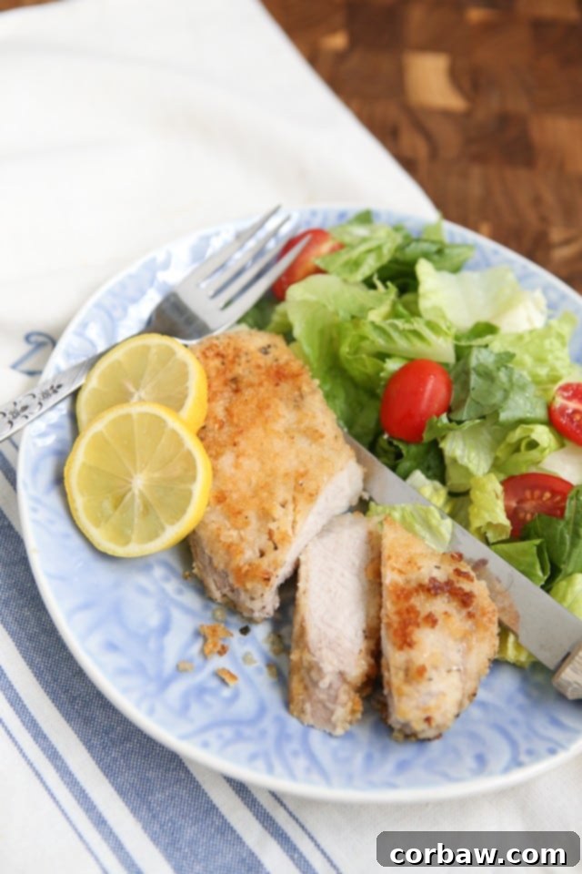 Close-up of baked Parmesan Pork Chops, showcasing their crispy breading and tender texture