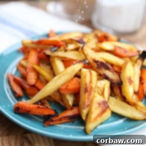 Perfectly golden-brown honey roasted parsnips and carrots, a close-up shot showcasing their delicious caramelization