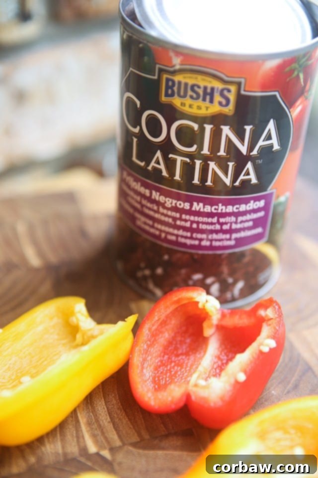 Mini Mexican Stuffed Peppers - baby bell peppers stuffed with black refried beans, salsa and cheese. Great side dish or appetizer and hard to resist! Recipe via aggieskitchen.com