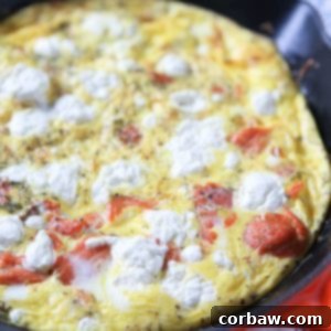 A beautifully baked smoked salmon frittata with goat cheese and dill, ready to be enjoyed.