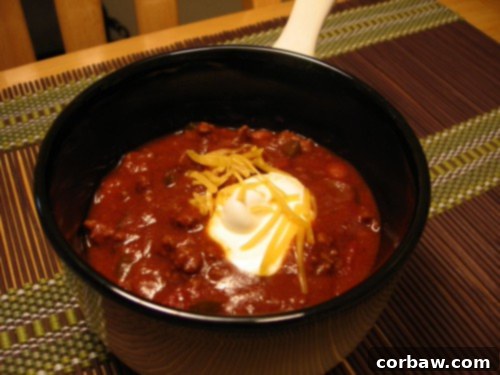 ChiliJenn - A classic, hearty chili with a rich red color, ready to be served.