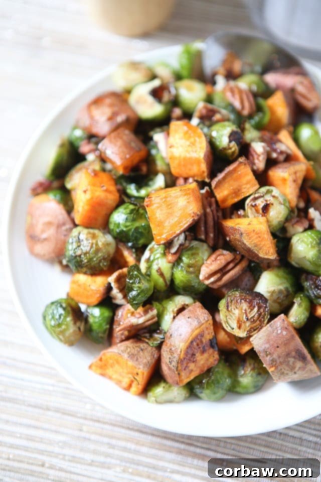 All the flavors of fall on a plate! Drizzled with a maple, balsamic and sriracha glaze....you'll love these Roasted Sweet Potatoes and Brussels Sprouts with Pecans #ThinkFisher