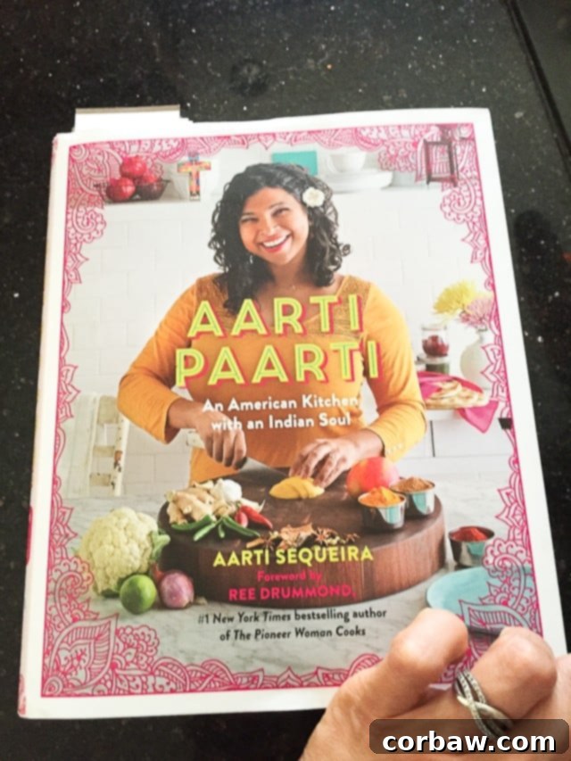 Aarti Paarti Cookbook: Ground Turkey and Spices Aarti Paarti cookbook prominently displayed, open to a recipe page, suggesting culinary inspiration.