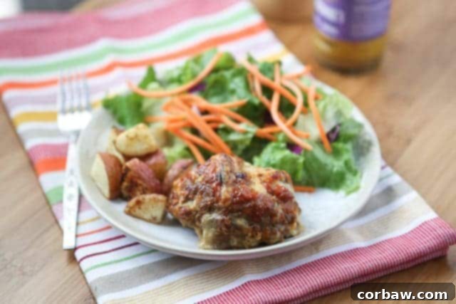 Mini Honey Mustard Meatloaf Meal A serving of Mini Honey Mustard Meatloaf, roasted potatoes, and a green salad on a plate.