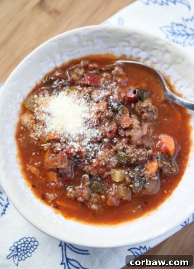 bowl of vegetable beef soup with parmesan cheese