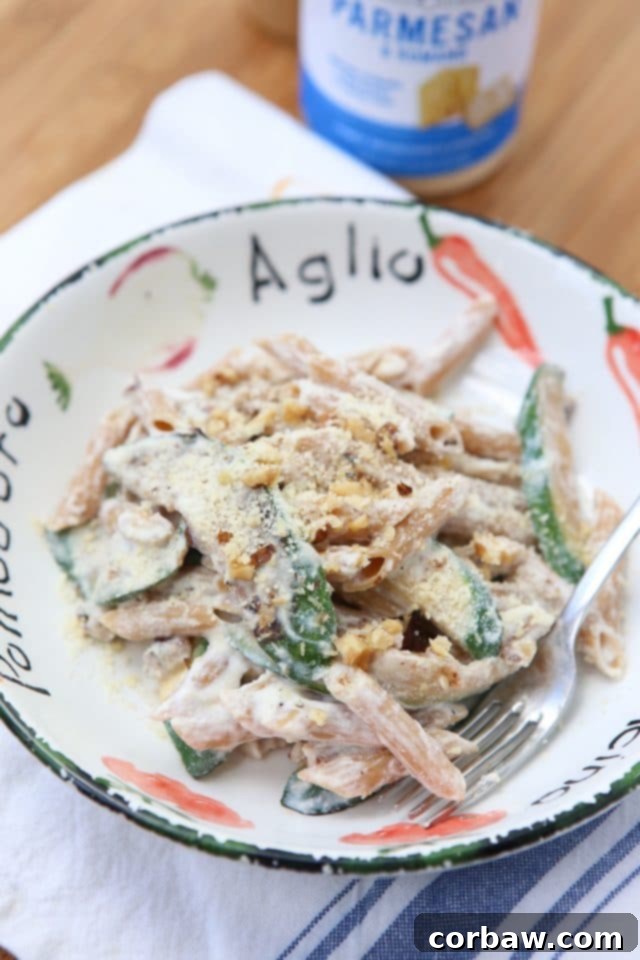 Creamy Whole Wheat Penne Pasta with Ricotta, fresh Zucchini, and crunchy Walnuts, served in a bowl, a healthy and comforting family meal.