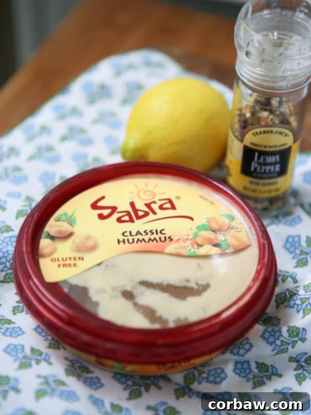 In need of an easy appetizer? Everyone loves a veggie plate! Spruce it up by serving fresh veggies with semi-homemade Lemon Pepper Hummus. Recipe via aggieskitchen.com #UnofficalMeal #NationalHummusDay