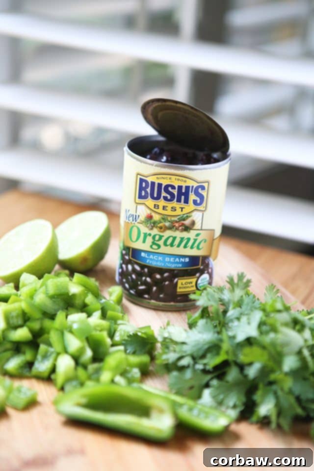 This Corn and Black Bean Quinoa Salad is bursting with freshness and flavor, making it an ideal introduction to quinoa. Recipe via aggieskitchen.com Close-up of the fresh and colorful ingredients in the Corn and Black Bean Quinoa Salad, highlighting the quinoa, black beans, corn, and chopped vegetables. Ideal for those wanting to incorporate more quinoa into their diet. Recipe via aggieskitchen.com