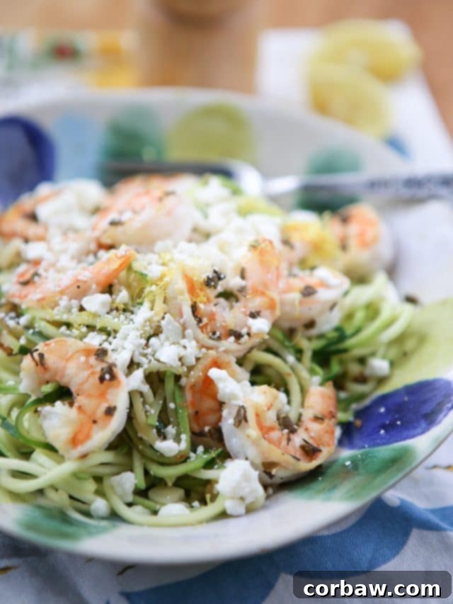 Skinnytaste Zoodles with Shrimp and Feta: Quick & Healthy A vibrant bowl of zucchini noodles topped with perfectly cooked shrimp and crumbled feta cheese, garnished with fresh herbs.