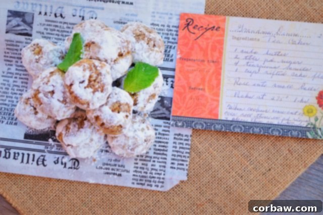 A festive close-up of healthy snowball cookies, or Russian Tea Cookies, tied with a red ribbon