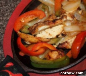 Sizzling Chicken Fajitas in a cast iron skillet