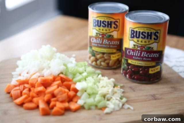 A vibrant and nutritious Slow Cooker Chicken and Farro Chili, featuring a medley of vegetables, lean chicken, and wholesome farro, enhanced by Bush's Chili Beans. Get the full recipe at aggieskitchen.com. Warm up this winter with Slow Cooker Chicken and Farro Chili - so hearty & healthy, filled with veggies, lean protein, whole grains and Bush's Chili Beans. Recipe via aggieskitchen.com