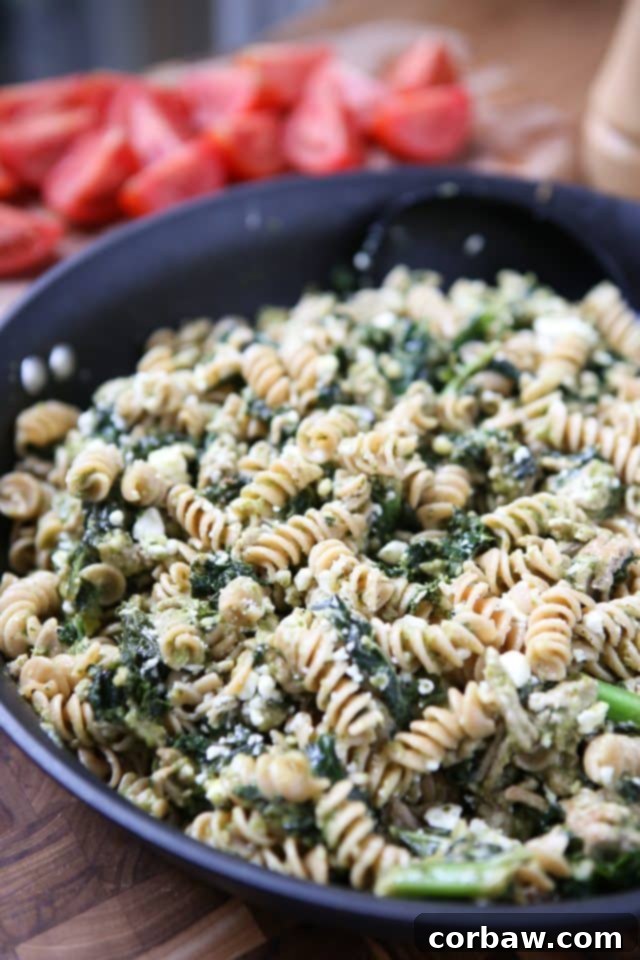 2016's 12 Most Popular Recipes My Must-Make List 18 Pesto Pasta with Turkey and Kale served in a bowl, showing the vibrant green pesto coating the pasta and vegetables.