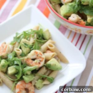 Roasted lemon pepper shrimp tossed with whole wheat pasta, plenty of creamy avocado, arugula, lemon and Parmesan - this Shrimp & Avocado Pasta is a heart-healthy dinner option perfect for any night of the week. Recipe via aggieskitchen.com
