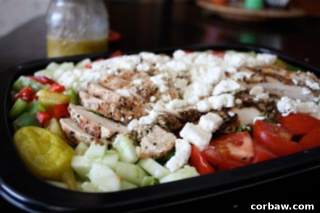 Greek Grilled Chicken Salad Close-up of freshly prepared Greek Grilled Chicken Salad, showcasing tender grilled chicken, vibrant vegetables, and crumbled feta cheese.