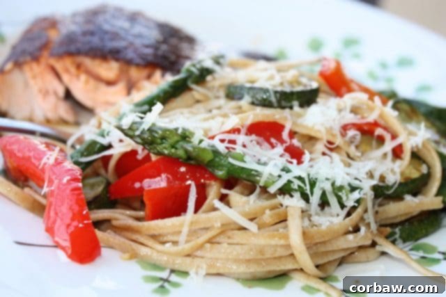 Spring's Bounty Whole Wheat Linguine 3 Close-up of freshly cooked Linguine with Spring Vegetables, highlighting the texture of whole wheat pasta and the colorful medley of sautéed zucchini, asparagus, and red bell peppers.