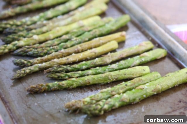 Easy roasted asparagus roasted asparagus on a sheet pan sprinkled with salt and pepper