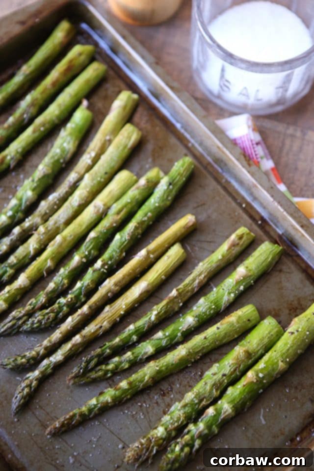 easy roasted asparagus recipe roasted asparagus on a sheet pan with salt and pepper