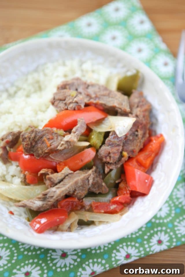 Ready-to-Serve Slow Cooker Pepper Steak Close-up of a bowl of Slow Cooker Pepper Steak, garnished with fresh herbs, ready to be served.