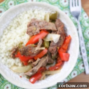 Hearty Slow Cooker Pepper Steak recipe card image, featuring tender beef and colorful vegetables.