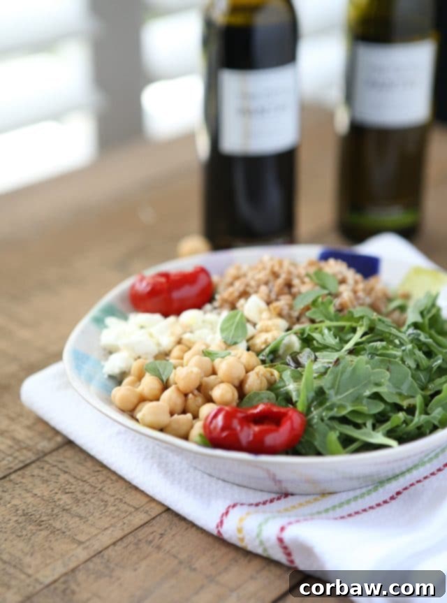 A beautifully plated Mediterranean Farro Salad with Arugula and Chickpeas, presented as a hearty and healthy vegetarian meal option. Recipe via aggieskitchen.com This Mediterranean Farro Salad with Arugula & Chickpeas is a hearty & healthy vegetarian whole grain dish. Great source of protein and fiber! Perfect for Meatless Monday! Recipe via aggieskitchen.com