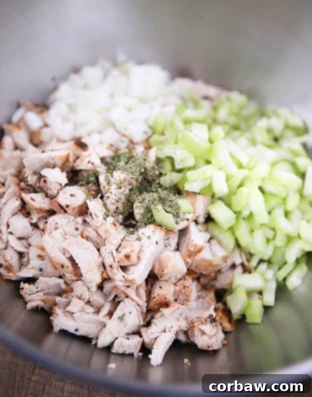 Grilled Lemon Pepper Chicken Salad with Greek Yogurt bowl of cut chicken, diced sweet onions, chopped celery, and various seasonings