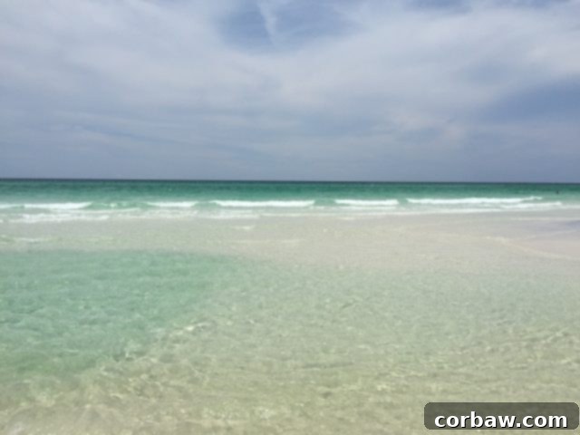 Experience the unparalleled beauty of 30A's Seaside beaches, a top family vacation destination Stunning view of 30A's emerald waters and pristine white sand beach, perfect for family relaxation