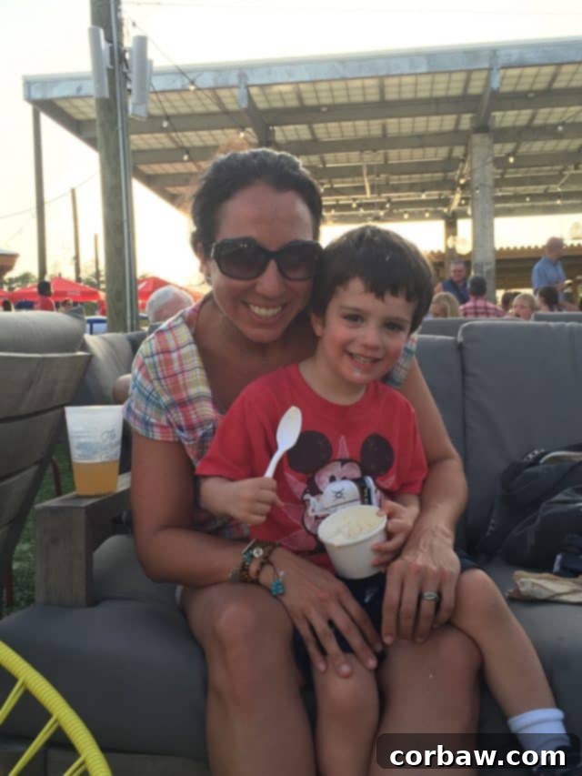 Children playing and relaxing during an outdoor movie at The Hub 30A Kids enjoying themselves on the grassy area in front of the big screen at The Hub 30A