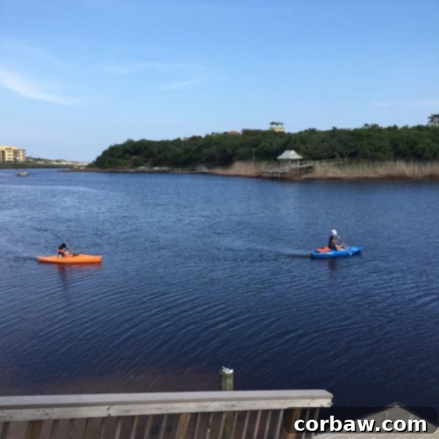 Kayaking as a fun way to explore Big Redfish Lake and reach the Gulf on 30A Kayaks lined up on the shore of Big Redfish Lake, ready for adventure