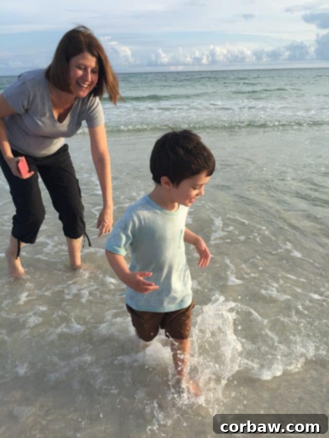 Excited kids exploring marine life on the stunning 30A coast A child delightedly holding a small crab found on the beach, a moment of discovery
