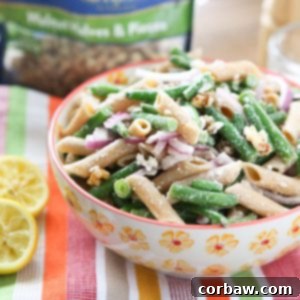 Lemony Green Bean Pasta Salad with Walnuts in a bowl, a refreshing and easy summer recipe.