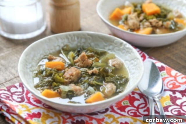 bowl of Italian sausage and kale soup on a colorful napkin with spoon