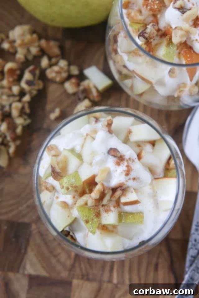 Top-down view of a vibrant Greek Yogurt Parfait with Pears and Walnuts, adorned with honey drizzle and spices, ready to be enjoyed as a wholesome fall meal or sweet treat.