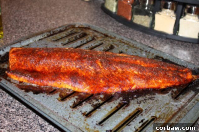 Sweet Heat Broiled Salmon 2 Raw salmon fillet on a roasting pan, prepared with the sweet and spicy rub, ready for broiling