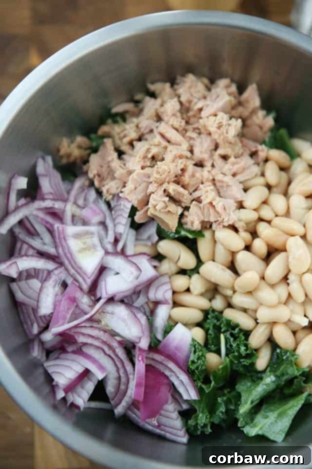 A beautifully composed Lemony Tuna and White Bean Kale Salad with Avocado, perfect for a low-carb, high-protein diet. #tuna #kale #salad #avocado #LowCarb #proteinrich
