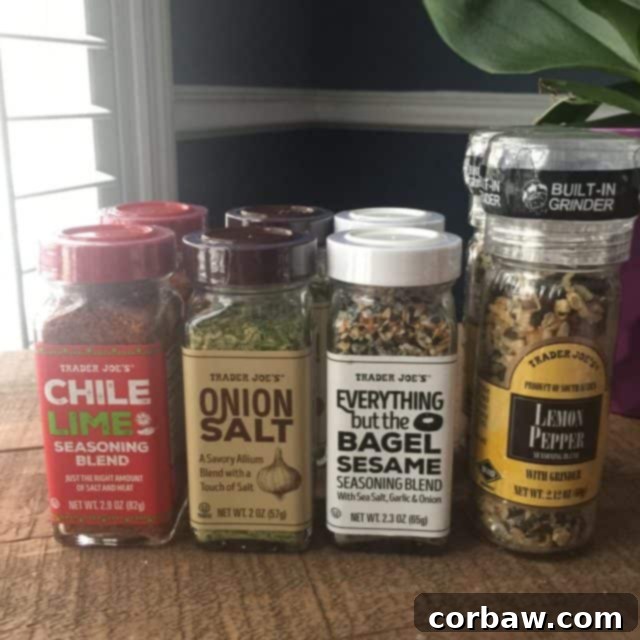 Trader Joe's Flavor Fiesta Spice Giveaway 2 A vibrant selection of Trader Joe's spices, including Chile Lime, Onion Salt, Everything But The Bagel, and Lemon Pepper, neatly arranged on a rustic wooden surface.