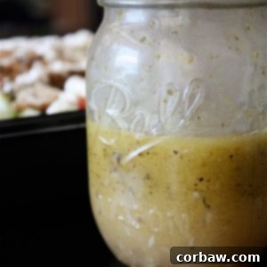 A vibrant Greek Grilled Chicken Salad, artfully arranged and drizzled with a homemade Greek Lemon Vinaigrette, showcasing a healthy and flavorful meal.