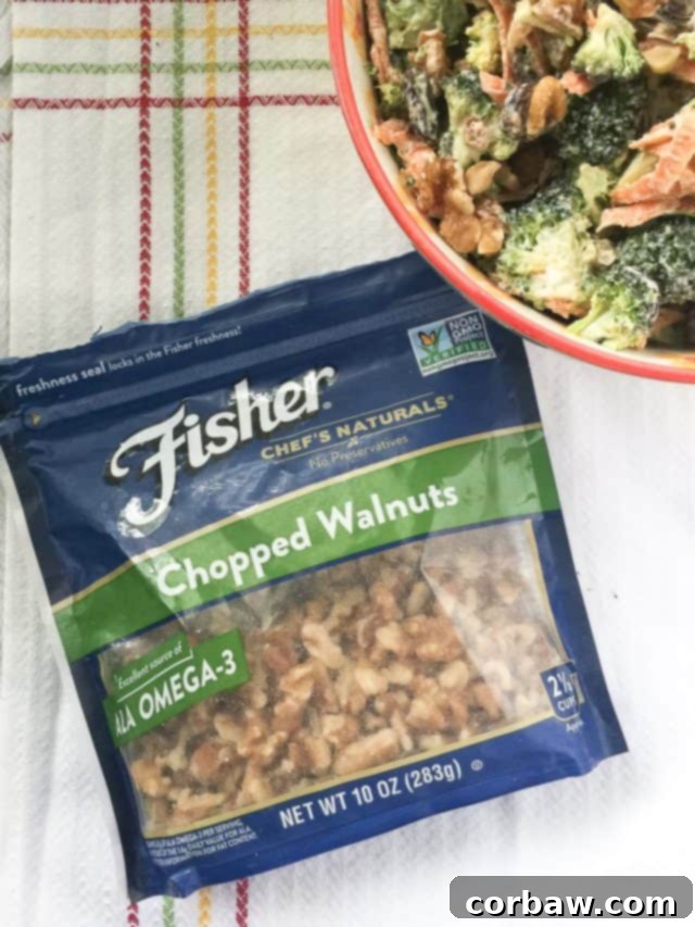 A serving of homemade broccoli salad with walnuts and raisins, presented in a rustic bowl on a wooden surface, highlighting its appetizing texture.