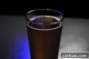 A close-up shot of the Honey Orange Wheat beer, showing its golden hue and frothy head.