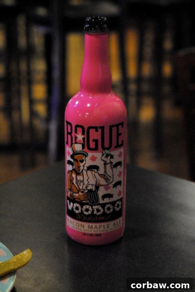 Two hands holding glasses of Rogue beer, one showing a lighter wheat beer and the other a darker, perhaps the Voodoo Doughnut Ale.