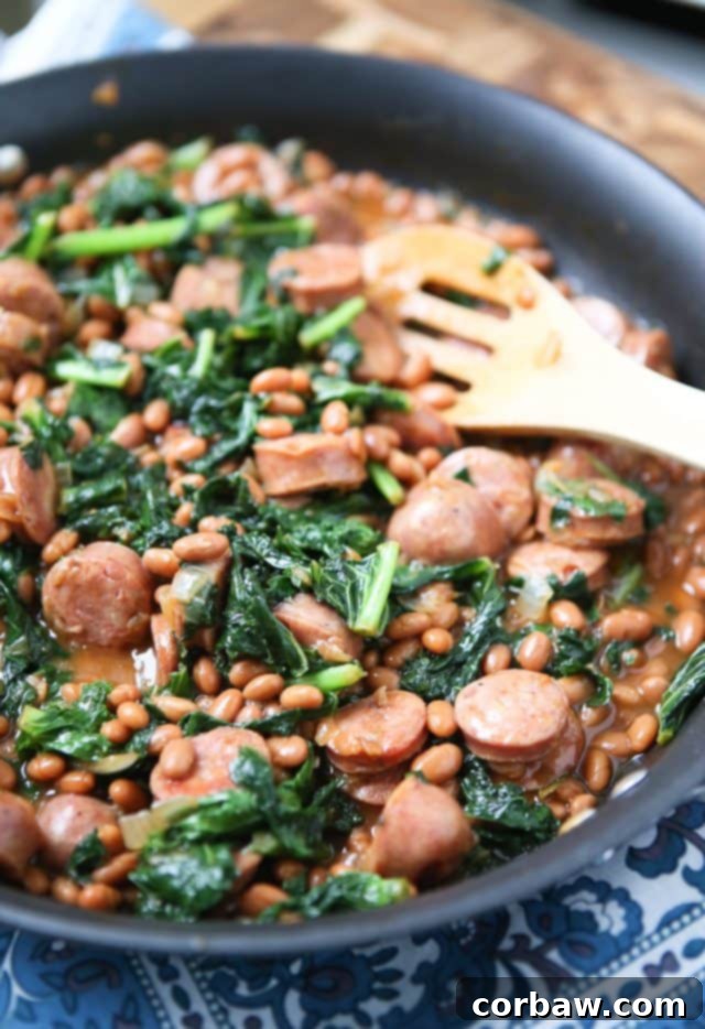 Easy comfort food your family will love! Baked Bean, Sausage & Kale Skillet - comes together fast, perfect for busy weeknights! Recipe via aggieskitchen.com