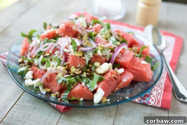 Close-up shot of Watermelon Feta Salad showing vibrant red watermelon cubes, crumbled white feta, and green basil leaves.