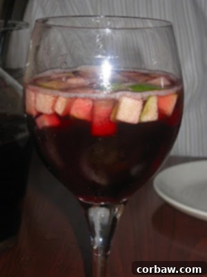 A refreshing carafe of vibrant red sangria, a perfect accompaniment to pizza